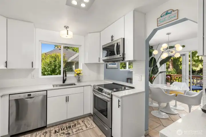 Stainless appliances, quartz countertops, and tiled backsplash inspired by the ocean waves. Stainless appliances, quartz countertops, and tiled backsplash inspired by the ocean waves.