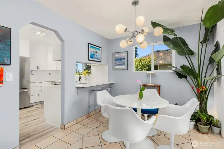 The dining area and kitchen flow seamlessly together, with a convenient pass-through window and bar seating. The dining area and kitchen flow seamlessly together, with a convenient pass-through window and bar seating.