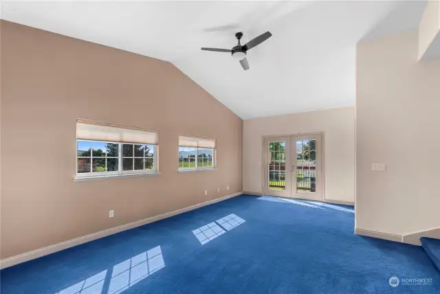 Primary bedroom with French doors leading out to upstairs deck