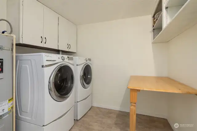 Huge laundry room with storage and folding space.