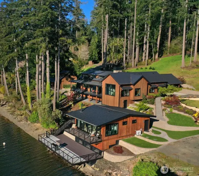 Luxurious waterfront Gig Harbor Estates, a crowning jewel nestled in the heart of the Pacific Northwest, with commanding views of the Olympic Mountains. This gated retreat offers an unrivaled blend of privacy, elegance, & natural beauty across 5.4 acres of awe-inspiring landscape. The estate is fully fenced and has 300+ feet of low-bank waterfront with moorage.