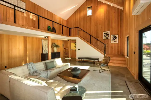 Tucked away on the 5.4-acre waterfront estate, this stunning standalone studio is a true gem. Soaring vaulted ceilings, rich wood interiors, and dramatic natural light create an inspiring, gallery-like space. Whether used as a creative retreat, guesthouse, or luxe work-from-home setup, this architectural beauty blends privacy, style, and versatility just steps from the main residence.
