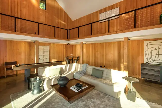 This expansive, light-filled studio space offers exceptional versatility with soaring ceilings, polished concrete floors, and warm wood finishes. Whether envisioned as a creative studio, game room, executive office, or an additional guesthouse, the open-concept layout and lofted mezzanine provide endless possibilities—all just steps from the main home on this stunning 5.4-acre waterfront estate. A truly flexible space designed to inspire.