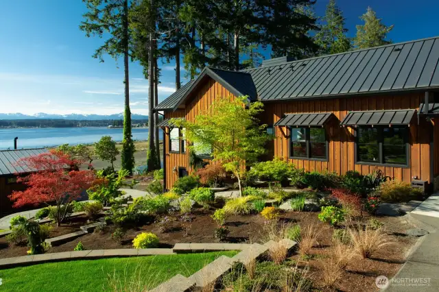 Step outside to the elegantly terraced gardens, which cascade gently towards the water, offering secluded nooks for intimate gatherings or quiet moments of solitude.