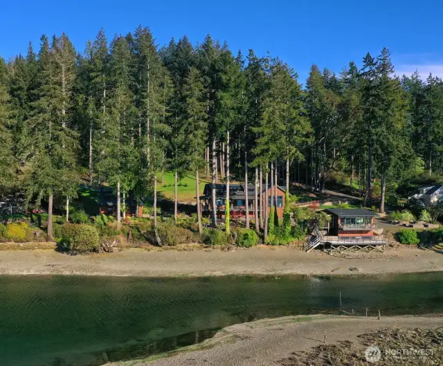 The property's design pays homage to the natural splendor that surrounds it, with rich wooden exteriors and large, luminous windows that capture the enchanting views from every angle.