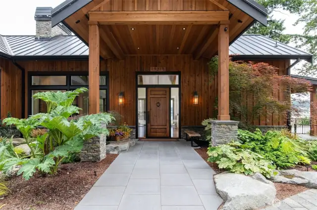 Covered walkway make this magnificent entry special with spectacular gardens and secluded waterfront wonderland.