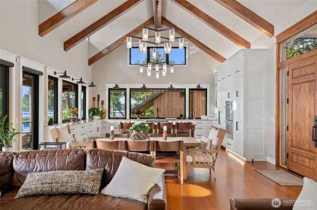 Great room is open to dining and kitchen with full wall of windows. Sliding doors open to make the exterior and interior one with spectacular views to Olympic Mountains and easy access to waterfront.