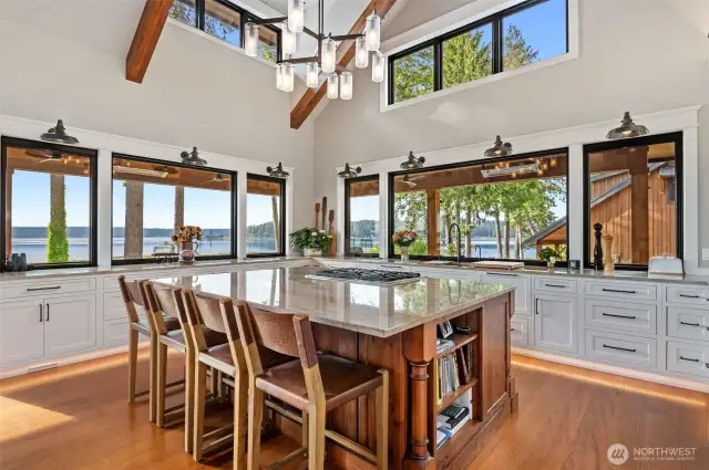The kitchen island has seating for four and enough space to cook and entertain in luxury. All electrical outlets are pop-up on the counter, and Thermodor appliances are throughout the kitchen and home.