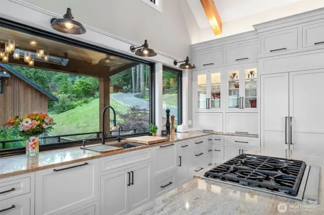 Custom refrigerator and cooktop with appliance garage details and pop-up door exposure. Dual Thermodor dishwashers give the owner the flexibility to have a small gathering or a large one without pressure for clean-up.
