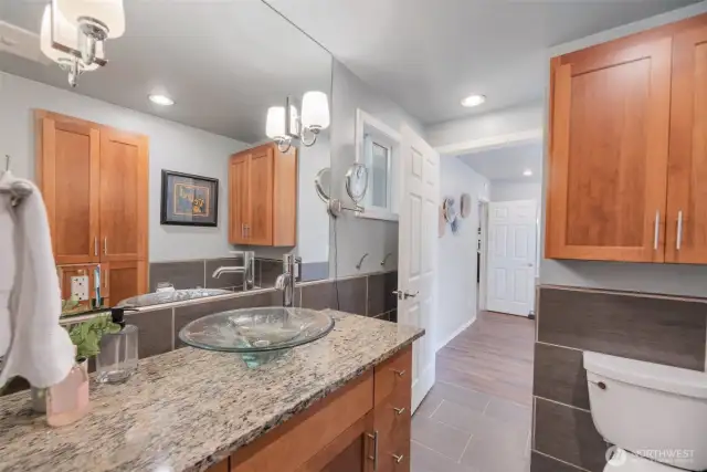 Primary bathroom boasts stunning remodel. Don't miss all the storage
