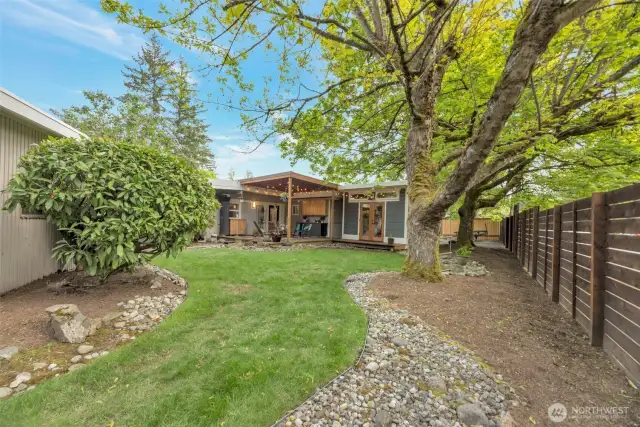 View from corner of yard behind garage. Fully fenced yard.