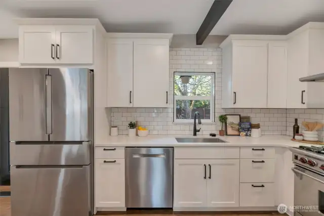 Quartz slab counters, custom backsplash, 'touchless' faucet and glass rinser.