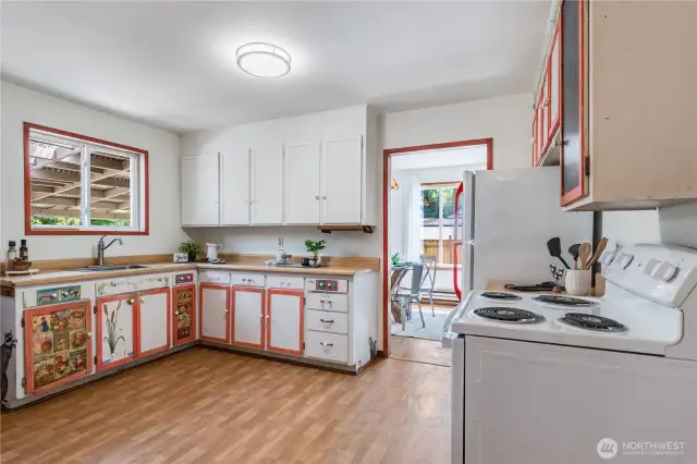This spacious country kitchen allows several people to create meals together. The owner's artistic designs add a cheerful touch.