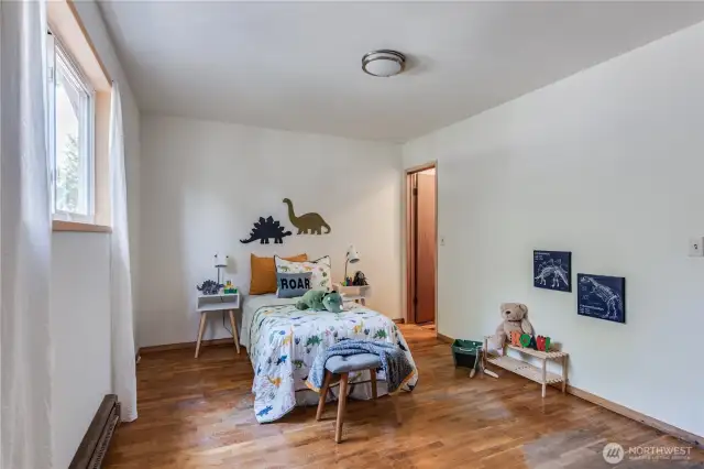 The third bedroom, on the east side of the house, features its own half bath. It's a perfect guest room, or make into the primary suite.