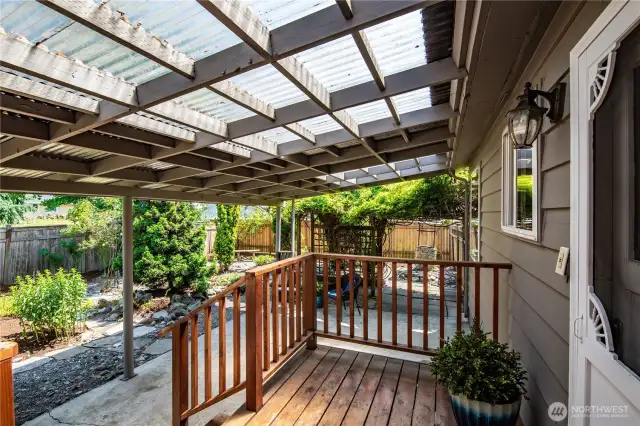 Stepping out the back door is this wonderful covered patio and deck. This can be a covered play space, an entertainment area in any weather, or just a great spot to unwind.