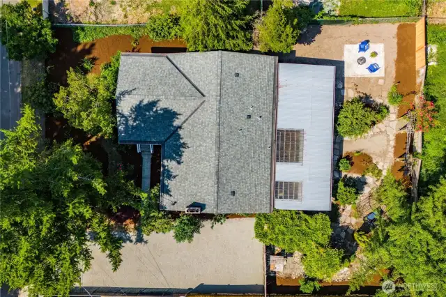 This bird's eye view shows the layout of the property, and the size of the covered patio in back. There's greenery all around for beautiful views through each window.