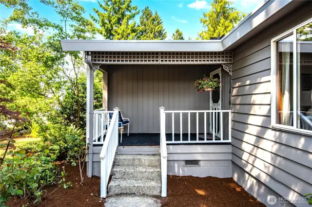 A darling covered porch provides a welcoming entry. Relax here with a favorite drink at the end of the day.