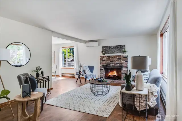 Enter into the living room of the home, where you'll find original hardwoods that extend throughout the main level.