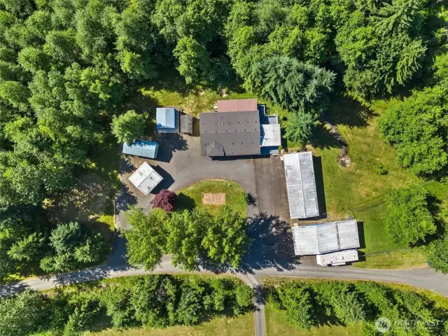 Aerial view of home and shops.