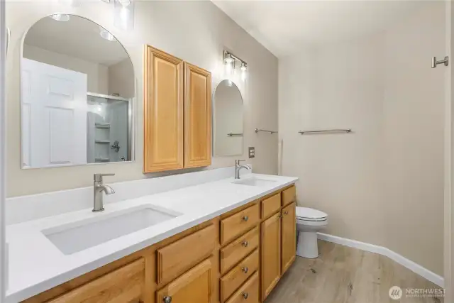 Modern touches and dual sinks elevate this primary bathroom