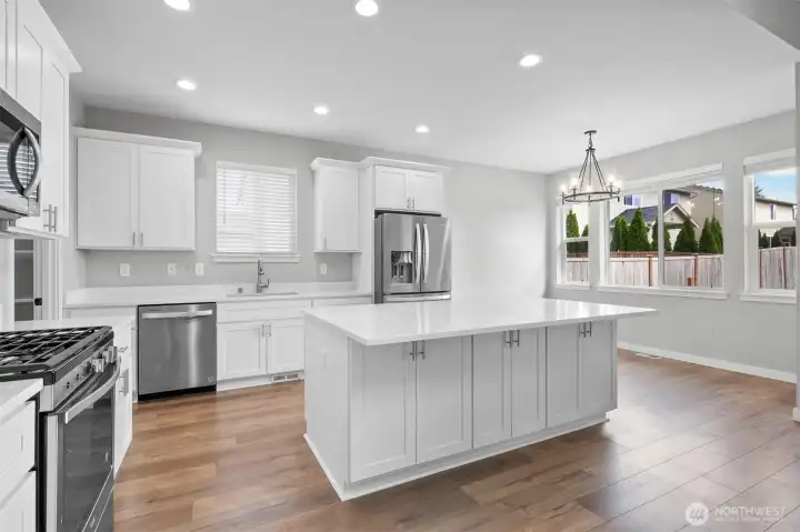 Prepare meals while guests relax at the quartz counter island. The island features plenty of extra storage in addition to the seating space.