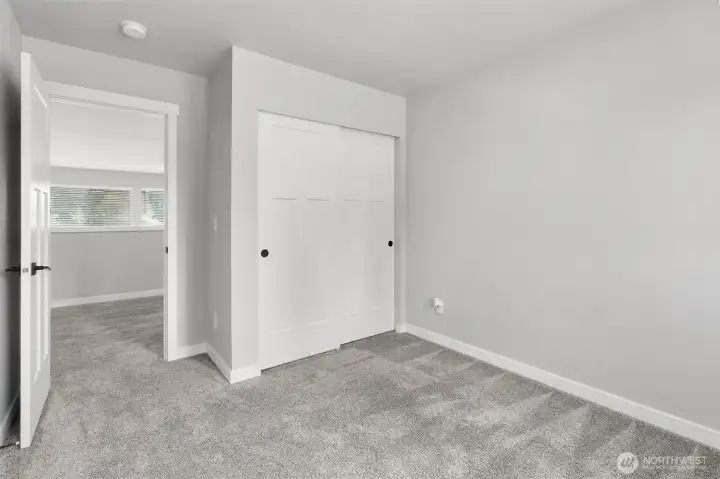 The additional bedrooms feature sliding door closets for plenty of storage.