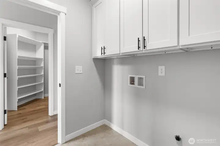 The utility room has plenty of storage situated above the washer and dryer area.