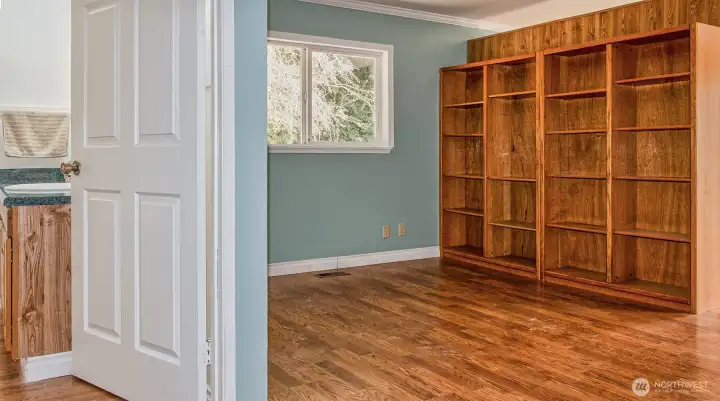 Full bath to large open bedroom with built-ins. Kitchenette on other side of bookcase