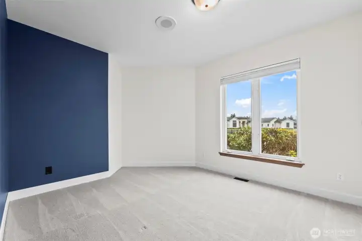 The second of the bedrooms with accent wall in the popular Benjamin Moore color, Hale Navy