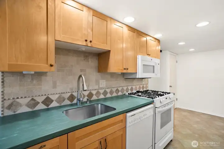 The galley kitchen has lots of counter and prep space on both sides, and under mount sink and soft close cabinets and drawers.