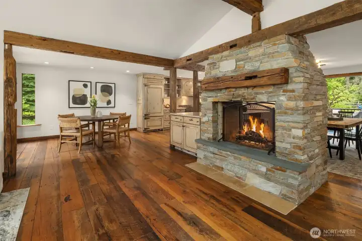 Rustic stone fireplace anchors the kitchen and living room