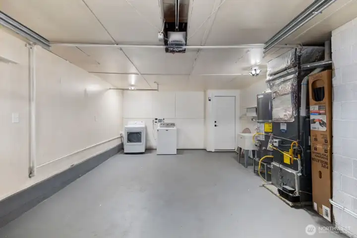 Additional garage angle shows built-in shelving and workspace possibilities.