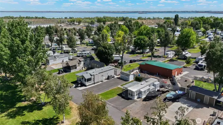 Grass and asphalt parking accommodate multiple vehicles.