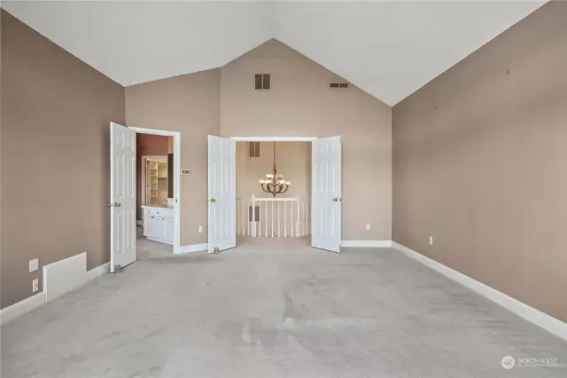 Vaulted ceilings accentuate the size and natural light in the primary bedroom, ensuite bath and walk in closet.