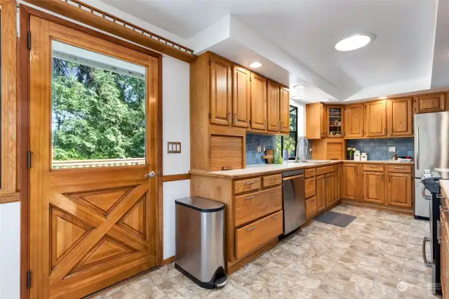 This door is beautiful! Garden window over sink, lots of cabinets and space for many cooks in the kitchen!:)