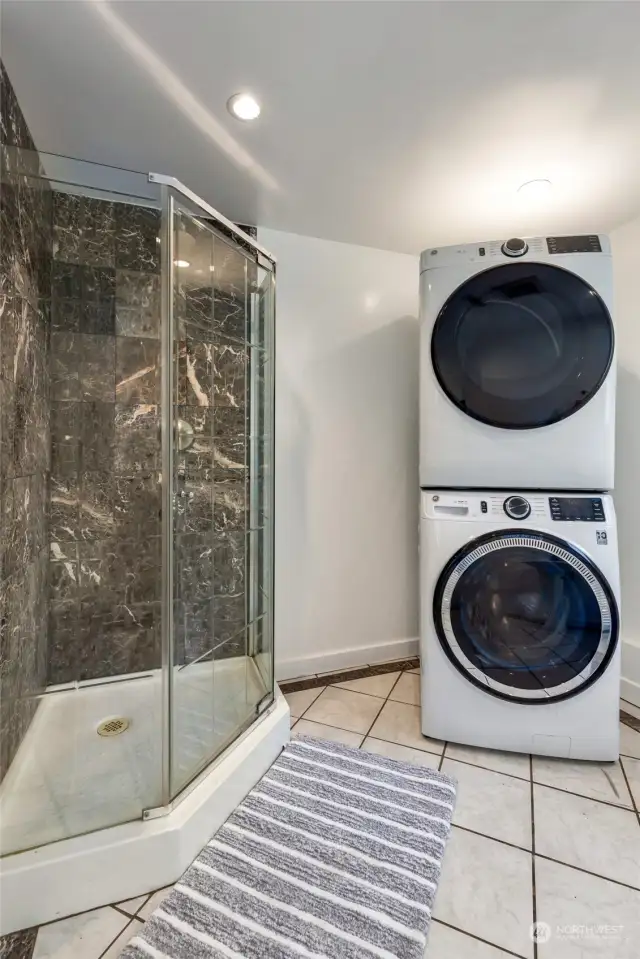 Bathroom downstairs with shower also has laundry area