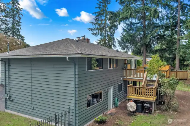 View of backyard of home. Man door to garage shown here