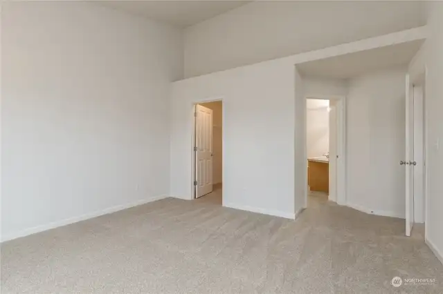 Primary bedroom has vaulted ceiling, large walk-in closet, private full bath