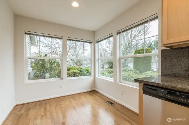 Corner breakfast nook with big windows for loads of natural light while thoughtful landscaping provides privacy