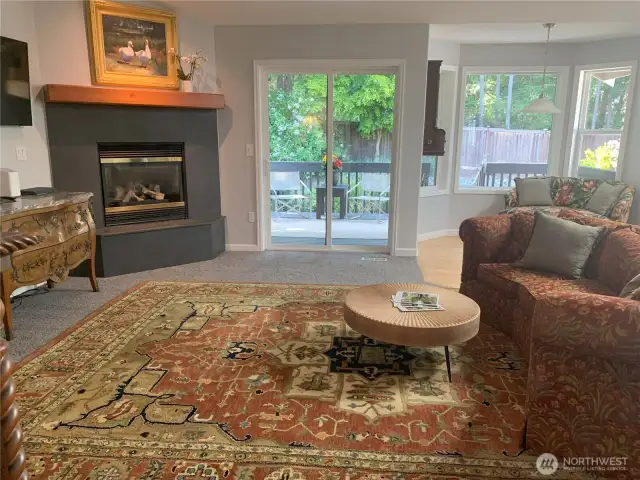 Family room with vaulted ceilings and Gas fireplace. Open back doors to covered patio