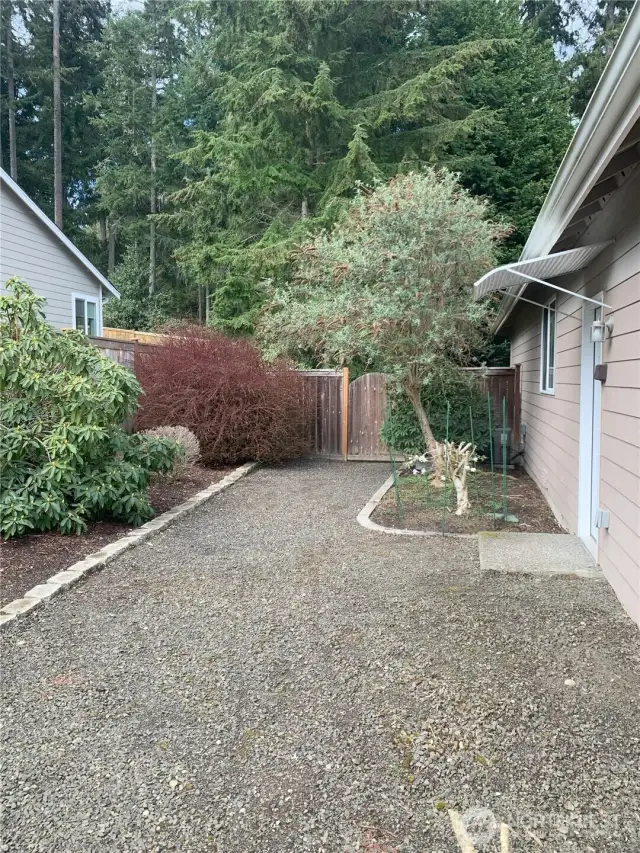 Side yard, gate opens to backyard AC located to right of gate