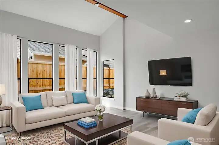 A wall of windows allows light to flood into this spacious living room. Virtually staged.