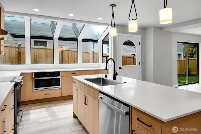 Gorgeous soft close cabinetry, stainless appliances, microwave drawer, endless slab quartz counters, and tons of storage!