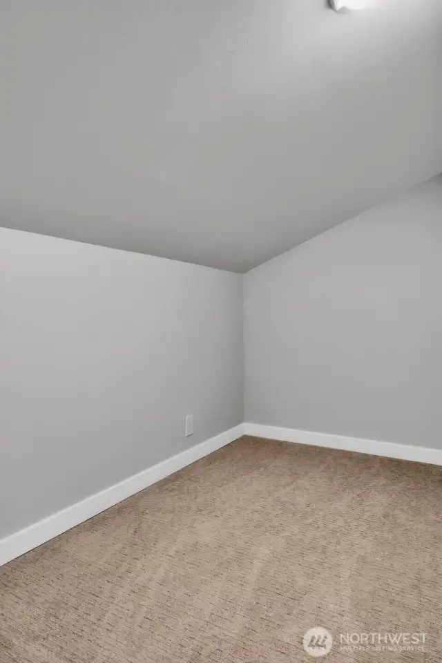 The secret room behind the closet in the vaulted bedroom is perfect for a reading nook or additional storage space.