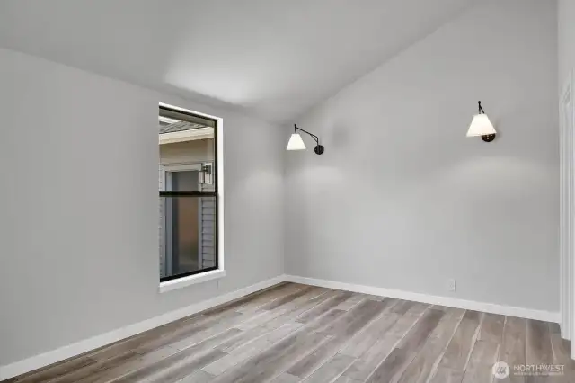 Vaulted ceiling in the ADU bedroom provides a sense of space and architectural interest.