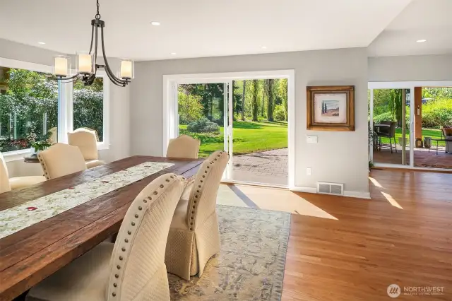 Looking from the kitchen is the large dining room, framed by a large wine bar / buffet table, and open to the family room providing many options to use as additional living space.