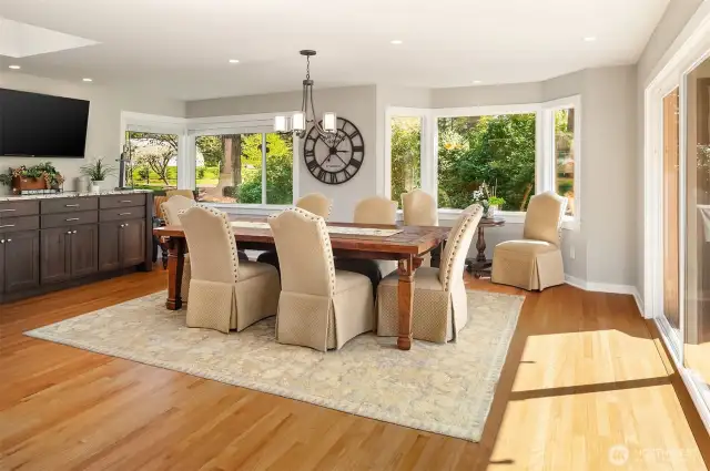 Looking from the kitchen is the large dining room, framed by a large wine bar / buffet table, and open to the family room providing many options to use as additional living space.