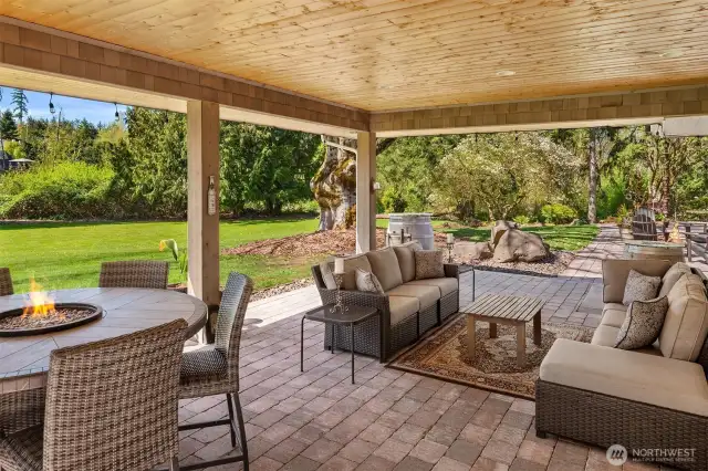 Expansive covered outdoor paver stone back patio-two large sliders as well as French Doors provide easy access.
