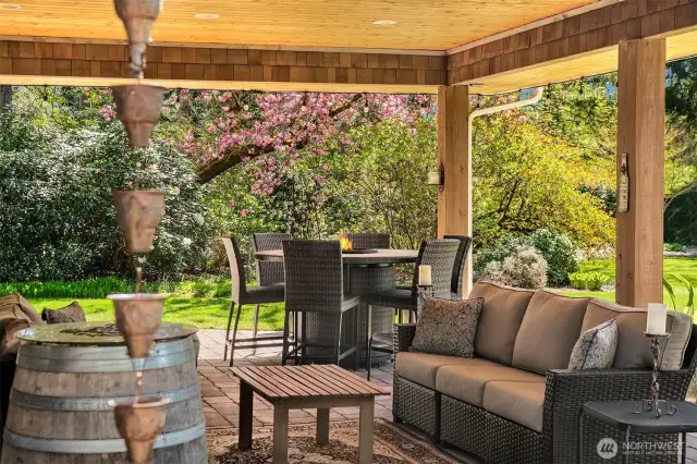 Expansive covered outdoor paver stone back patio-two large sliders as well as French Doors provide easy access.