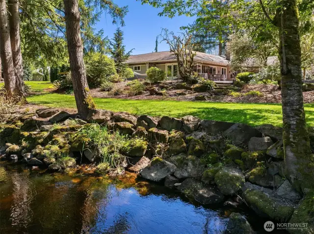 A Gardeners paradise, beautiful level lot with incredible privacy watch the salmon swim up Bear Creek from your lawn.